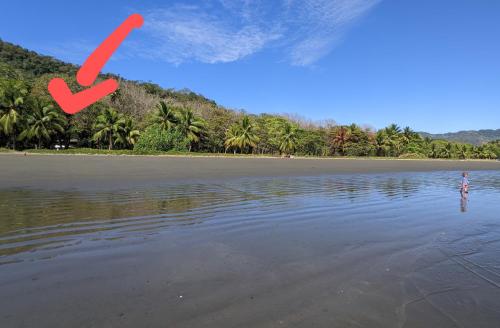 a person standing in the water on a beach at Ocean View in Puntarenas