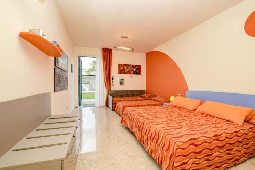 a bedroom with two beds and a couch at La Forgia Apartments in Peschiera del Garda