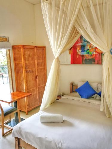 a bedroom with a bed with a canopy at Cornerstone Bali Coworking in Canggu
