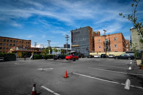 an empty parking lot with cars parked in it at H by H Hospitality in Los Angeles