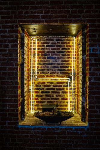 a brick wall with a fountain in front of a brick window at H by H Hospitality in Los Angeles