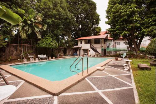 a swimming pool with a slide in a yard at Casa Heradurra Uno/Dos in Manila