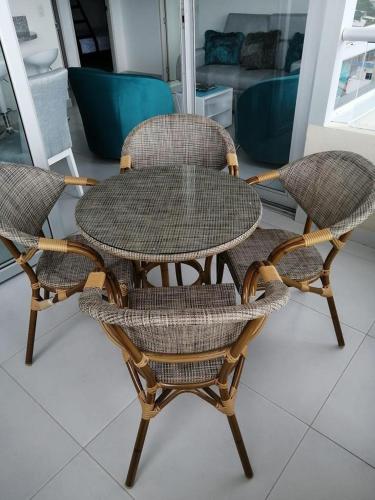 a table and two chairs sitting next to each other at Apartamento - Velas al Mar, Santa Marta in Gaira