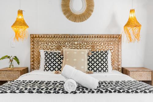 a bedroom with a bed and a mirror on the wall at Azur Byron Bay in Byron Bay