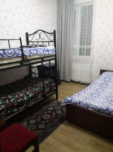 a bedroom with two bunk beds and a window at Guesthouse MARA in Bakuriani