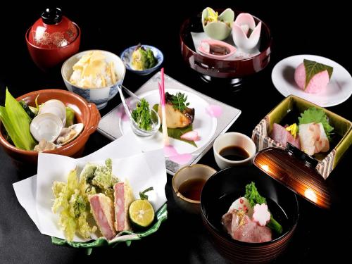 a variety of foods are arranged on a table at Hotel Nagaragawa No Sato in Gifu
