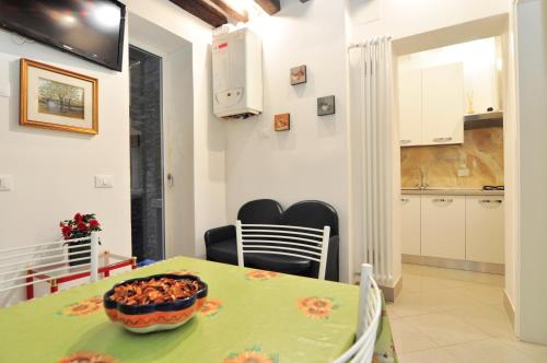 a kitchen and dining room with a green table and chairs at COZY APARTMENT NEAR RIALTO BRIDGE/ ST.MARK SQUARE in Venice