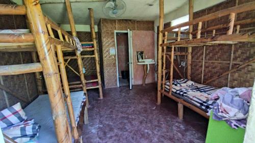 a room with two bunk beds and a hallway at SunnySide bed & bar in Siquijor