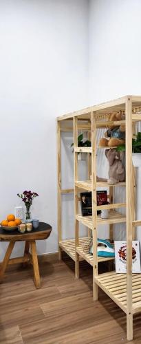 a room with a table and a book shelf at Bcons Garden Luxury Aparment in Dĩ An