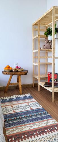 a room with a table and a book shelf at Bcons Garden Luxury Aparment in Dĩ An