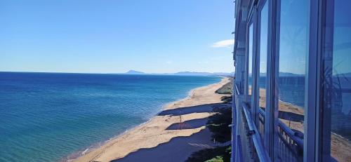 a view of the ocean from a building at SUNSET ROOM AT FRONT BEACH - HABITACION EN LA PLAYA en Piso compartido in Tavernes de Valldigna