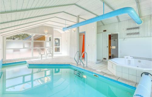 a bathroom with a swimming pool and a tub and a sink at Poolhaus 1 In Hohendorf in Hohendorf