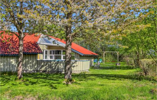 a house with a red roof in a yard with trees at Poolhaus 1 In Hohendorf in Hohendorf