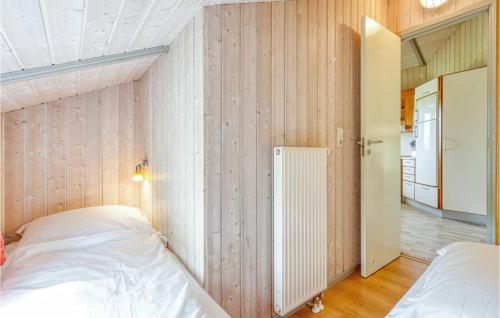 a bedroom with two beds and an open door at Poolhaus 1 In Hohendorf in Hohendorf