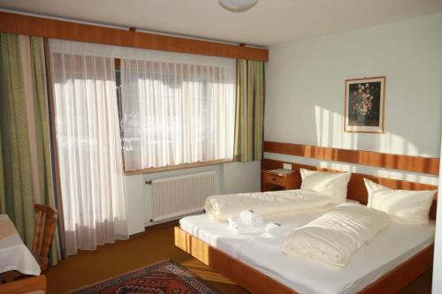 a bedroom with two beds and a large window at Haus Kristall in Bach