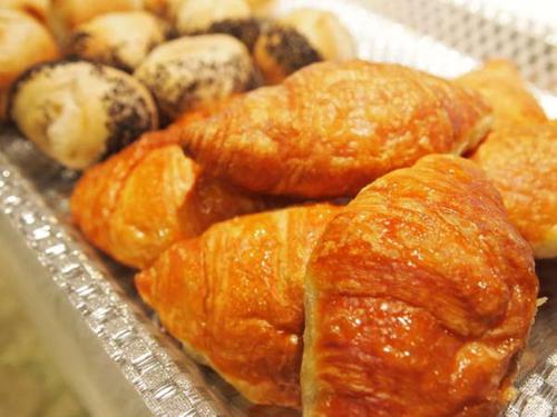 a bunch of different types of pastries on a tray at Ark Hotel Osaka Shinsaibashi -ROUTE INN HOTELS- in Osaka