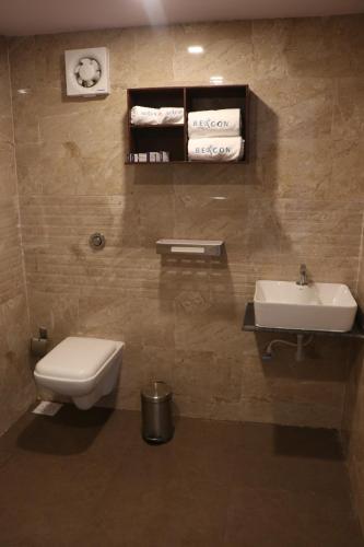 a bathroom with a toilet and a sink at Nest Beacon Resort Daman in Daman
