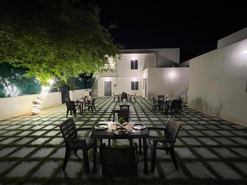 a table and chairs on a patio at night at Hostel ivory in Jaipur