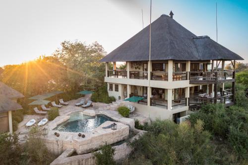 a large building with a pool and a house at Makumu Private Game Lodge in Klaserie Private Nature Reserve