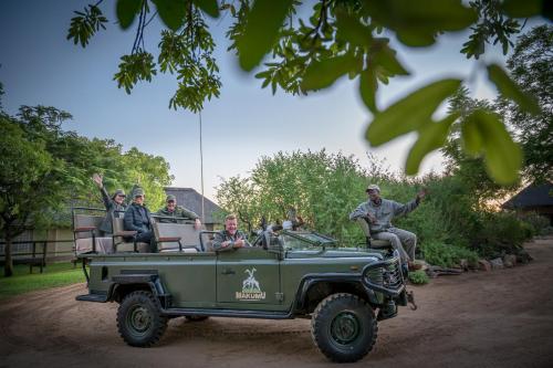 a group of people riding in the back of a jeep at Makumu Private Game Lodge in Klaserie Private Nature Reserve