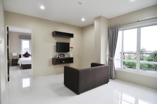 a living room with a couch and a tv at Khao Rang Place in Phuket Town