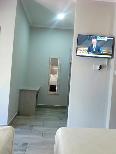 a hospital room with a tv on a wall at Amariah Lodge in Kasane