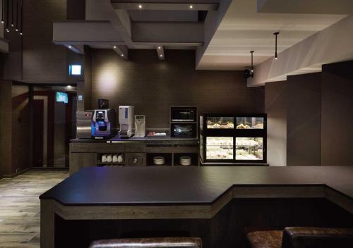 a kitchen with a table and a counter top at At Home Hotel Ximen in Taipei
