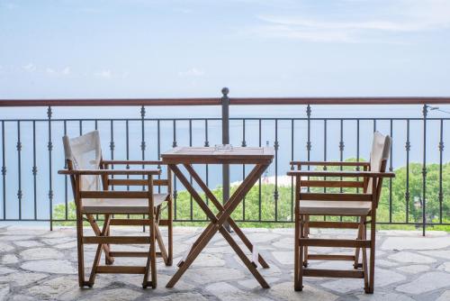 two chairs and a table on a balcony with the ocean at Marabou Hotel Chorefto in Chorefto