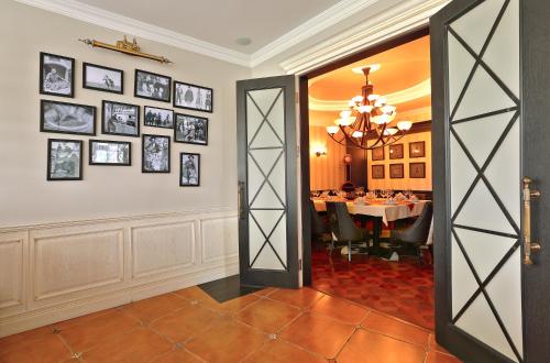 a dining room with a table and a chandelier at Diplomat Hotel by AG Hotels Group in Astana