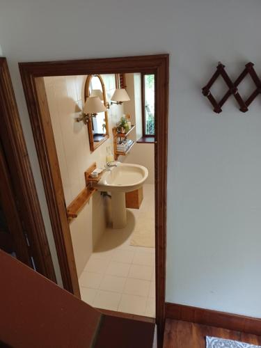 a bathroom with a sink and a mirror at Daniela B&B Affittacamere in Castiglione di Garfagnana