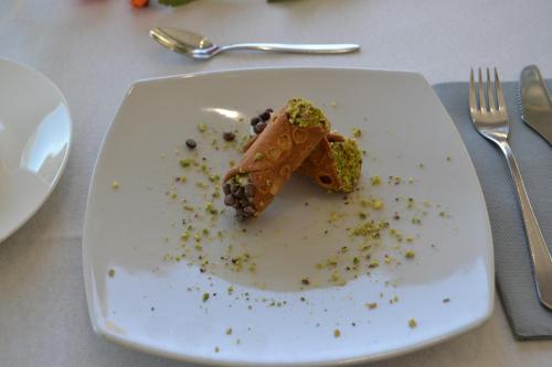 a white plate with a piece of food on it at B&B Sole&Sale in San Leone