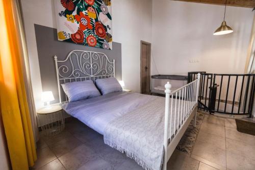 a bedroom with a white bed with a picture on the wall at Villa Eximia Novigrad in Novigrad Dalmatia