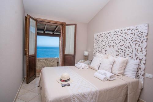 a bedroom with a bed with a view of the ocean at Porto Corallo Frontemare in Villaputzu