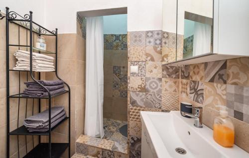 a bathroom with a sink and a mirror and towels at Villa Eximia Novigrad in Novigrad Dalmatia
