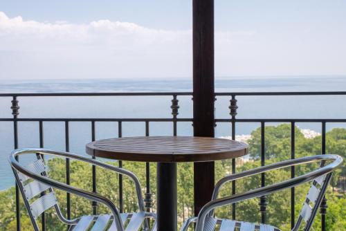 a table and two chairs on a balcony with the ocean at Marabou Hotel Chorefto in Chorefto