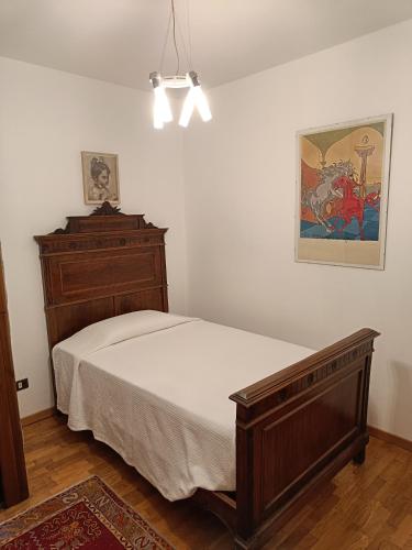 a bedroom with a bed and a dresser at Maison Santa Giustina in Salò