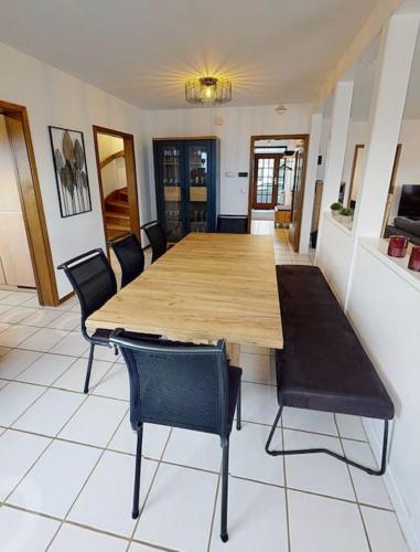 a dining room with a wooden table and chairs at FERIENHAUS in der Natur in Wüstenrot