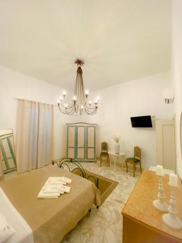 a living room with a bed and a chandelier at La Casa di Nonna Sisina in Mola di Bari