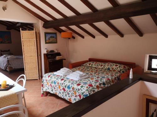 a bedroom with a bed and a table at La mansarda del Sacro Bosco in Bomarzo