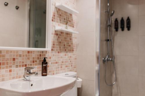 a bathroom with a sink and a toilet and a shower at Patacona Beach Apartment in Alboraya