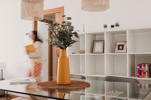 a vase sitting on a glass table in a room at Patacona Beach Apartment in Alboraya