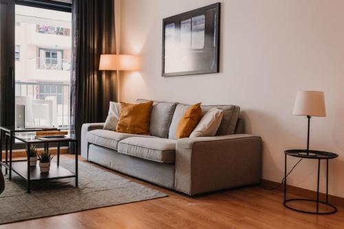 a living room with a couch and a window at Patacona Beach Apartment in Alboraya