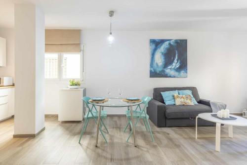 a living room with a couch and a table at Loft Santa Lucia Centro in Málaga