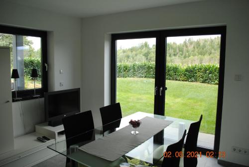 a dining room with a table and chairs and a window at Ferienappartment Lahnhöhe in Laurenburg