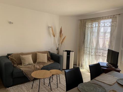 a living room with a couch and a table at Bel appartement sur le port du Brusc avec sa place de parking privative. in Six-Fours-les-Plages