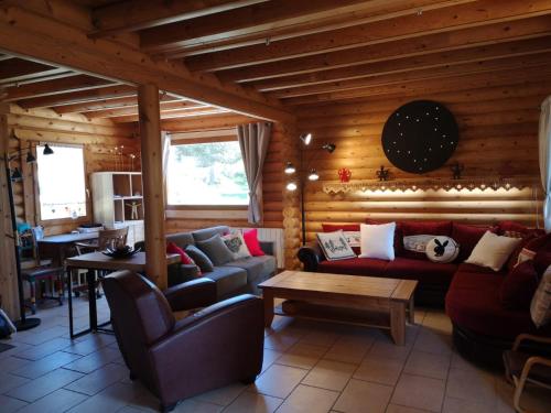 a living room with couches and a table at Chalet de charme authentique in Bolquere Pyrenees 2000