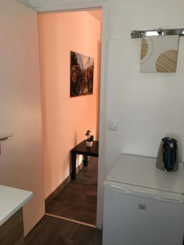 a kitchen with a washer and dryer and a table at Hotel Roc de St Miquel & Apartment in Soldeu