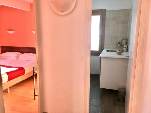 a room with a bed and a kitchen with a sink at Hotel Roc de St Miquel & Apartment in Soldeu