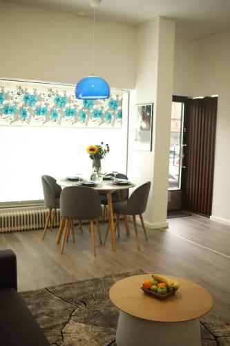 a dining room with a table and chairs and a blue light at City Center 2-rooms apartment in Vaasa