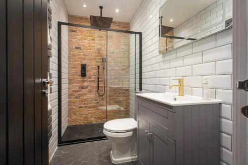a bathroom with a shower and a toilet and a sink at Capri Stays - Apartment Two - Two Bed Apartment in Blackpool